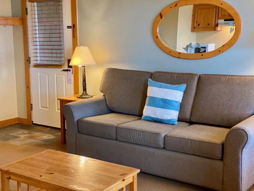 a living room with a couch and a table at Lighthouse Inn in Cannon Beach