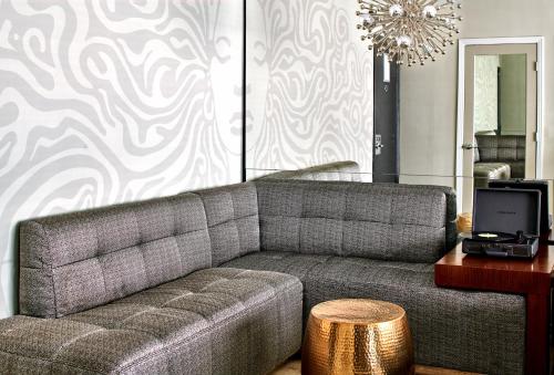 a living room with a couch and a table at Hotel Ziggy On Sunset in Los Angeles
