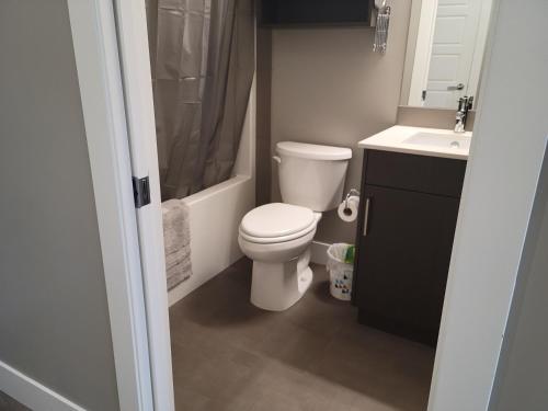 a bathroom with a toilet and a sink at Cozy Studio Suite, 15min walk to downtown in Kelowna