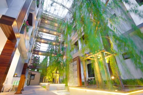 a building with a tree in the middle of it at New Siam Palace Ville Hotel in Bangkok