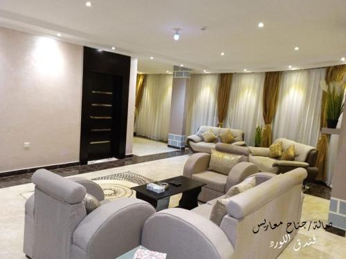 a large living room with couches and a table at Al Lord Hotel in Hafr Al Baten