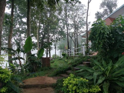 a path leading to a house with trees at Ban Chomdoi Resort PhaTang in Ban Pha Tang