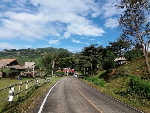 an empty road in a village with houses at Ban Chomdoi Resort PhaTang in Ban Pha Tang