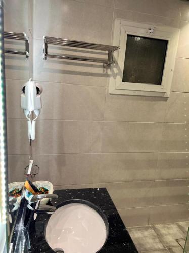 a bathroom with a toilet and a window at Lahdat in Jeddah