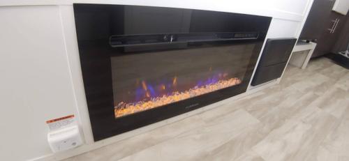 a fireplace in a living room with a stove at Pacific Dunes Resort in Copalis Beach