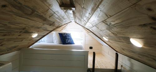 a small bed in a tiny house with a window at Pacific Dunes Resort in Copalis Beach