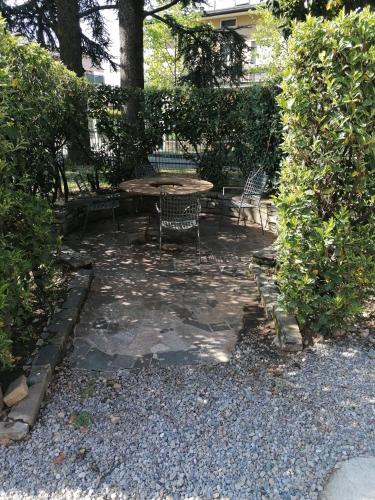 a patio with a table and chairs in a garden at Ferrari Formula 1 in Orio al Serio