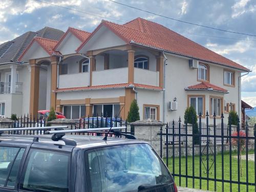a car parked in front of a house at Absolut Residence Hateg in Haţeg