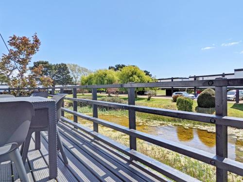 a wooden deck with a bench and a river at 6 Avocet Quay, Emsworth in Emsworth