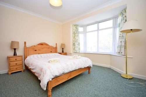 a bedroom with a bed and a window at St Marys, Hayling Island in South Hayling