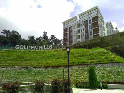 a building with the words golden hills next to a street light at Golden Hill 1 Room Apt at Night Market in Cameron Highlands