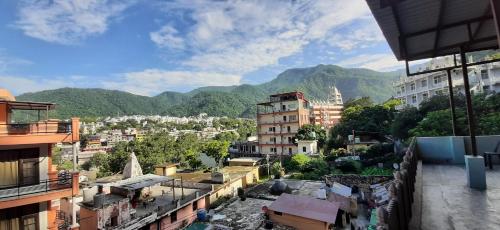 a view of a city with mountains in the background at HOTEL DIVYA in Rishīkesh