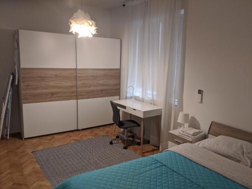 a bedroom with a desk and a bed and a desk and a chair at Small cozy apartment near the center of Plovdiv in Plovdiv