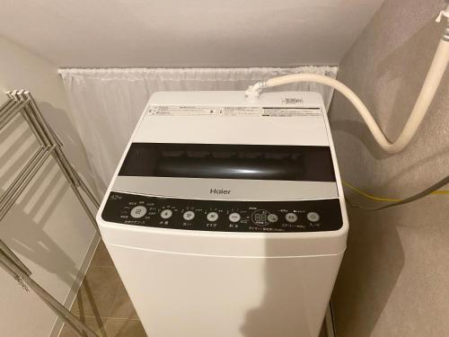 a microwave oven sitting in a corner of a room at TABISAI HOTEL Terrace 博多 in Fukuoka