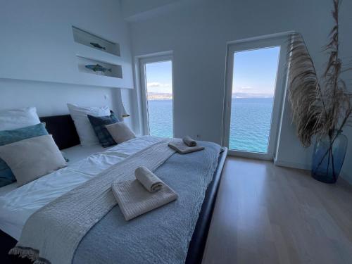 A bed or beds in a room at First row to the sea - Nautilus Deluxe Apartment