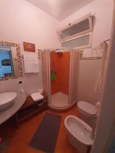 a bathroom with a shower and a toilet and a sink at Santa Ola in Levanto