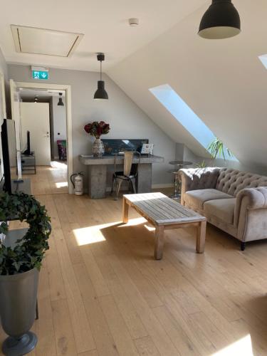 a living room with a couch and a table at Brohuspark in Lomma