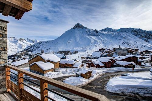 a village covered in snow with a mountain in the background at Résidence Almes1 et Almes 2 in Tignes