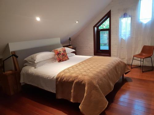 a bedroom with a bed with a pillow and a window at The Sanctuary - garden oasis in South Fremantle in South Fremantle