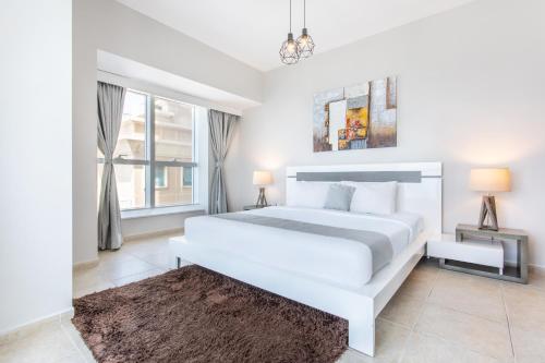 Un pat sau paturi într-o cameră la Icon Casa Living - Elite Residence Tower