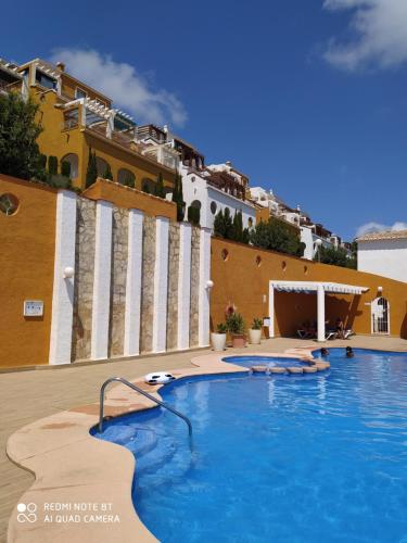 a large swimming pool in front of a building at Vista Divina in Cumbre del Sol
