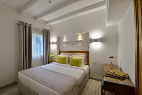 a hotel room with a bed and a desk at Sealine Beach, a Murwab Resort in Mesaieed