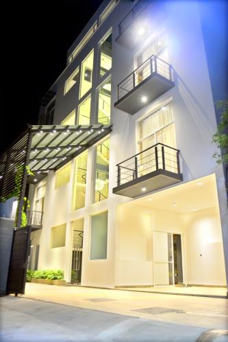 a white building with two balconies on the side of it at Belmont Boutique Hotel - Free Airport Shuttle Service in Negombo