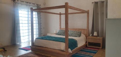a bedroom with a canopy bed in a room at Villa Talassa in Le Morne