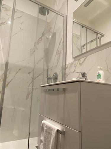 a bathroom with a shower and a sink and a mirror at JUST LAKE in Bellagio