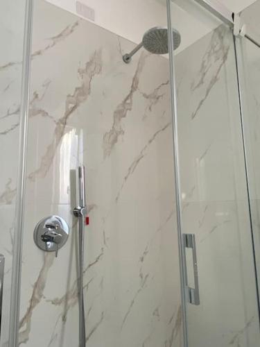 a shower with a glass door in a bathroom at JUST LAKE in Bellagio
