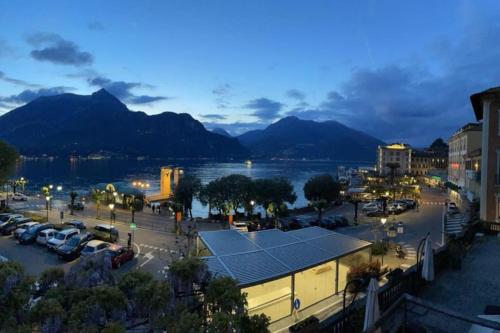 a city with a parking lot and a body of water at JUST LAKE in Bellagio