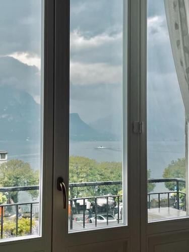 an open window with a view of a balcony at JUST LAKE in Bellagio