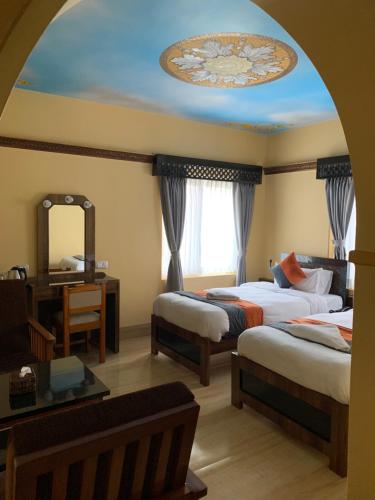a hotel room with two beds and a mirror at Hotel ABC, Boutique Hotel in Pokhara in Pokhara