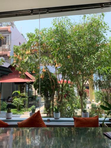 a view of a tree from a restaurant window at Hotel ABC, Boutique Hotel in Pokhara in Pokhara