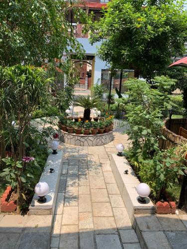 a garden with plants and trees and a walkway at Hotel ABC, Boutique Hotel in Pokhara in Pokhara