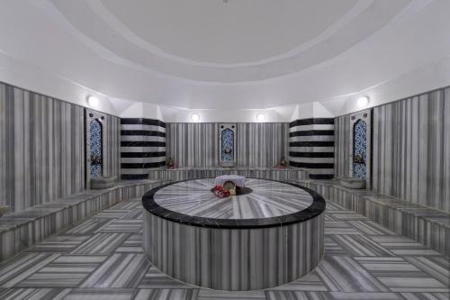 a large room with a round table in the middle at Turquoise Hotel in Side