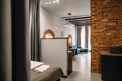 a room with a bed and a brick wall at Apartamenty K2 Podmurna 36 in Toruń