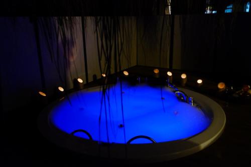 a blue tub with lights in a dark room at Mossa Afkule Kayaköy in Fethiye
