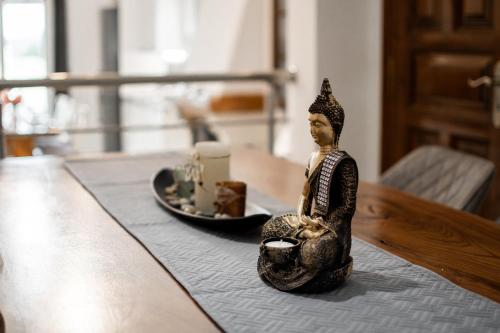 a figurine of a man sitting on a table at GKK House private swimming pool luxury house in Skriperón