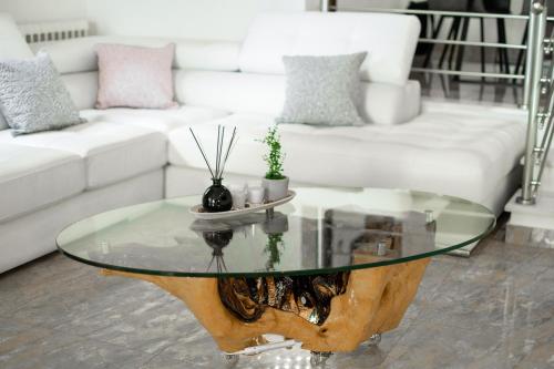 a living room with a table and a couch at GKK House private swimming pool luxury house in Skriperón