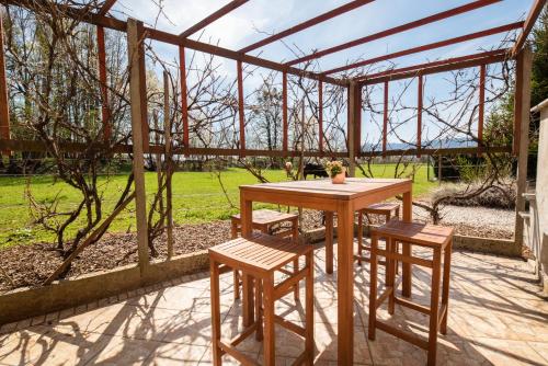 a wooden table and two stools and a table and chairs at Apartment Tiara 2 in Rodine