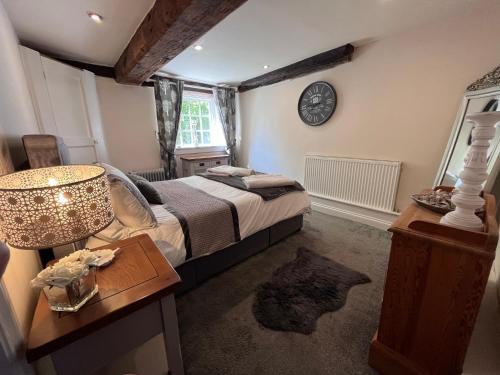a bedroom with a bed and a table with a lamp at The Mill in Hinton on the Green