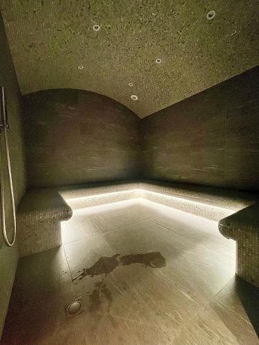 a dark room with a pool of water on the floor at Luxueux appartement skis aux pieds, jacuzzi privatif in Courchevel