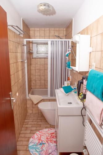 a small bathroom with a toilet and a sink at Haus Haeger in Dahme