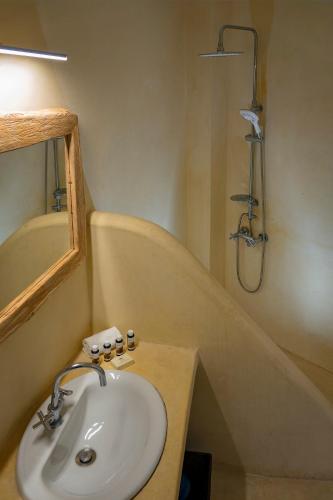a bathroom with a sink and a shower at Zefiros in Karavostasi