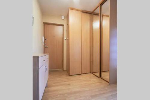 an empty room with a bathroom with wooden cabinets at Cozy private room in a three room apartment Free parking Feel like at home in Vilnius