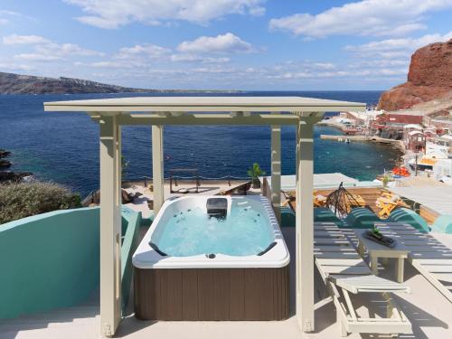 a hot tub on the deck of a cruise ship at Secret Gem Suites in Oia