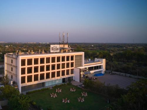 a large building with a crowd of people in front of it at Pride Biznotel Manjusar Vadodara Near Sokhda Lake in Vadodara