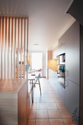 a kitchen with a table and a dining room at Studio Juliette in Stavelot