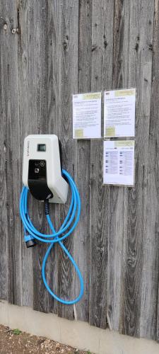 a phone hooked up to a fence with a blue hose at Brigel-Hof in Meßkirch